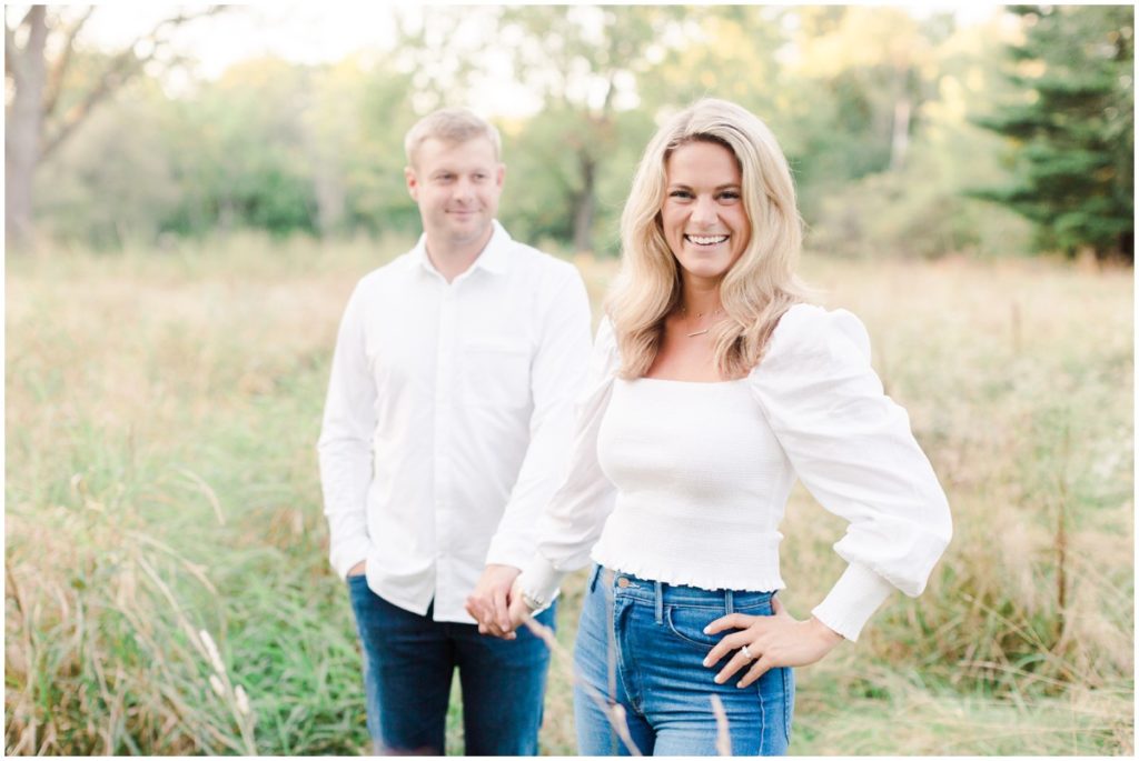 couple posing in a field for their chagrin falls engagement session