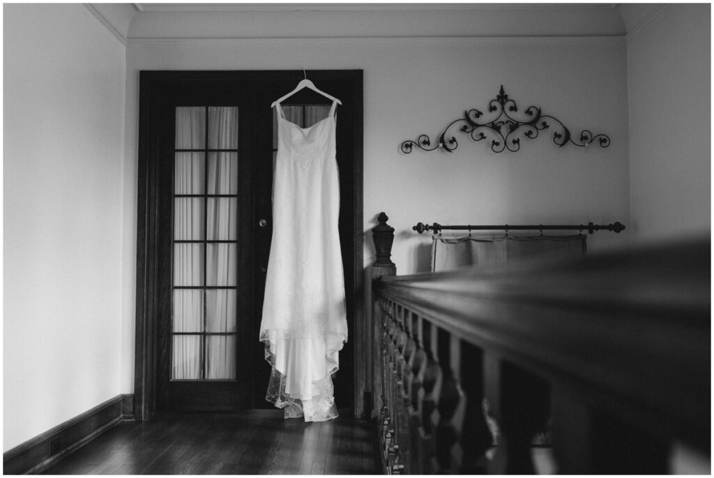A black and white photo of a wedding dress at Tudor house on portage lakes