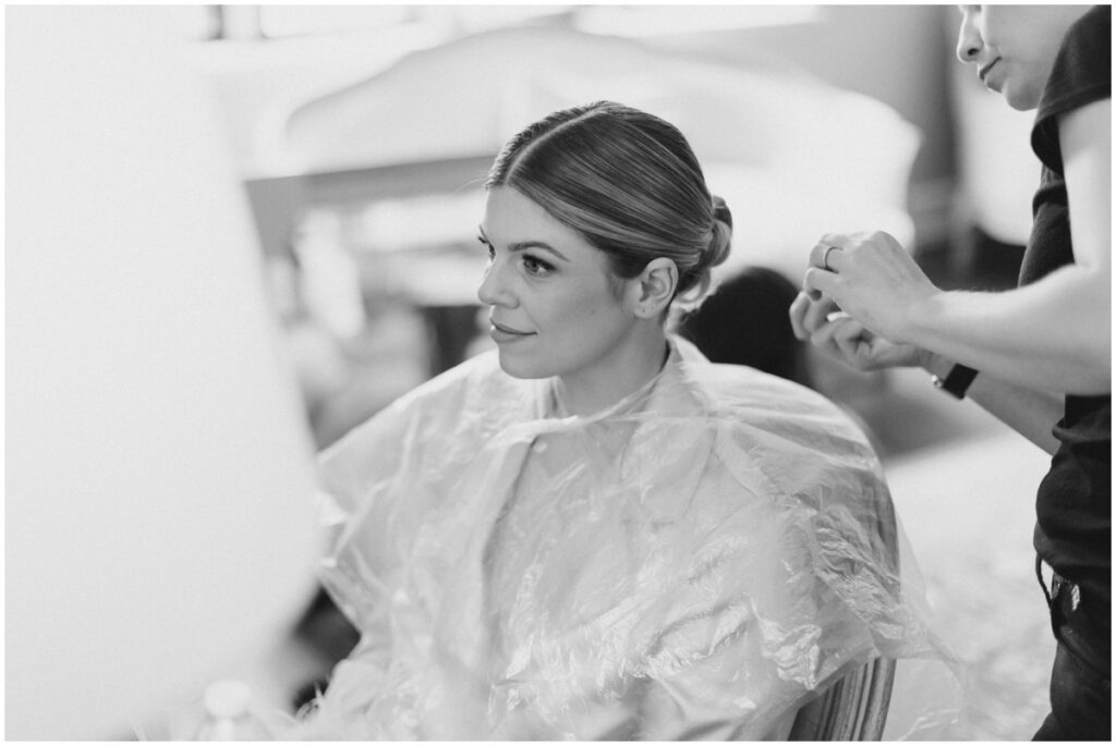 a bride getting her hair done on her wedding day