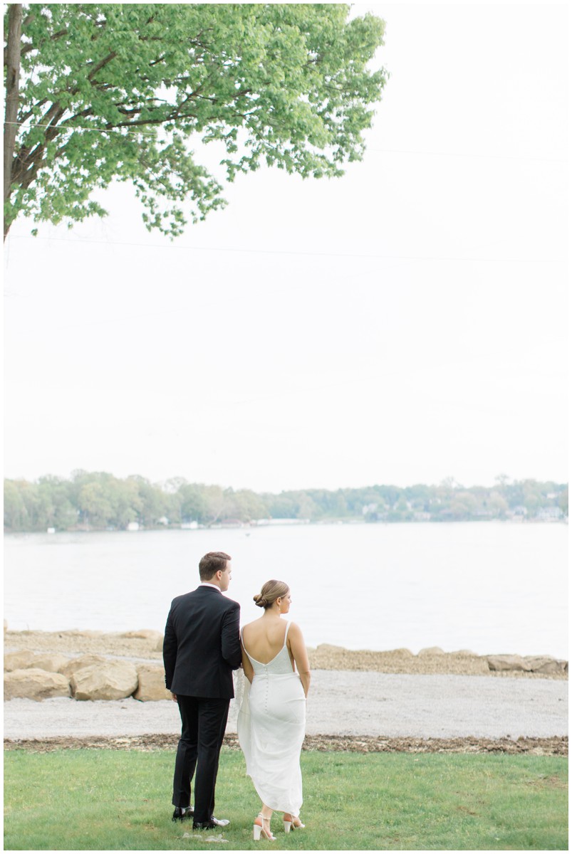 a bride and groom walking over looking portage lakes