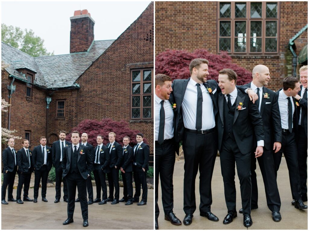 a groom and his groomsmen posing in front of the Tudor house at mason's cove wedding venue