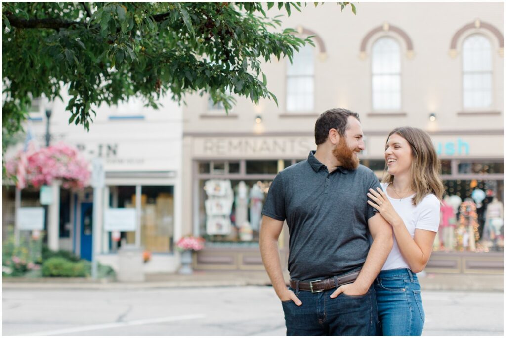 a couple posing in downtown chagrin falls for their engagement session
