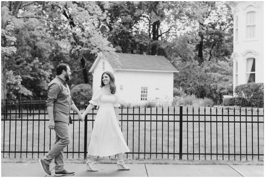a couple walking on the sidewalk through chagrin falls for their engagement session