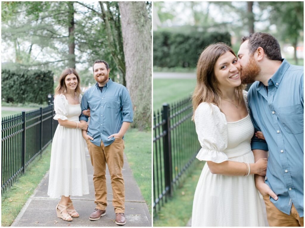a couple posing and smiling at the camera for their downtown chagrin falls engagement session