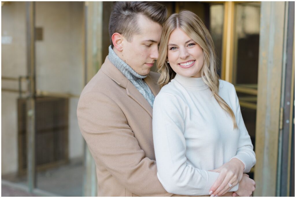 An engaged couple posing outside Terminal Tower in Cleveland Ohio for their engagement session