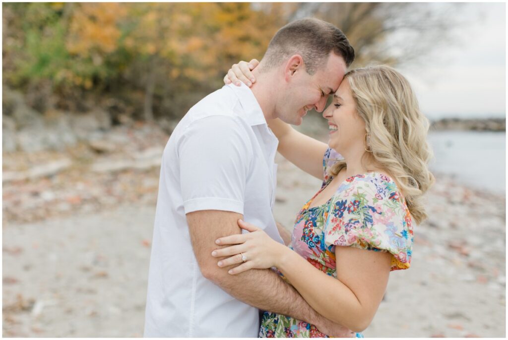 An engaged couple posing at Edgewater park for their engagement session